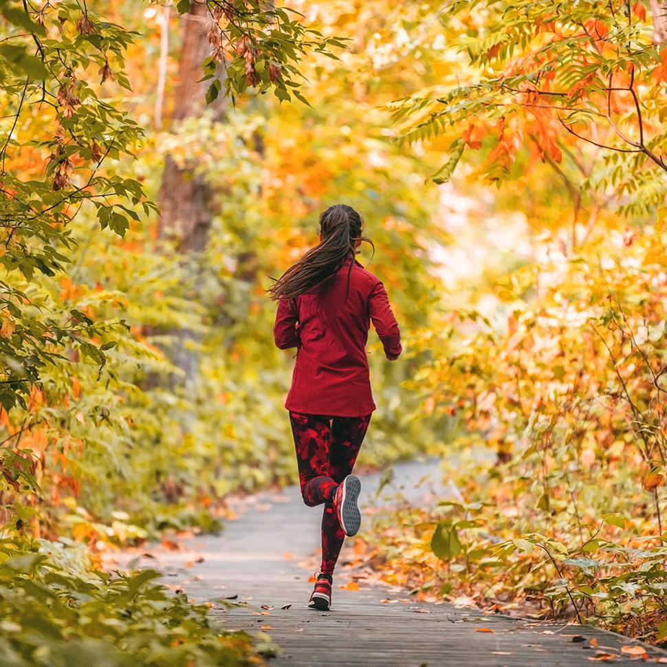 Woman jogging in park with red jumper