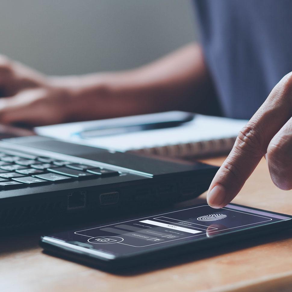 Person authenticating on a phone with finger