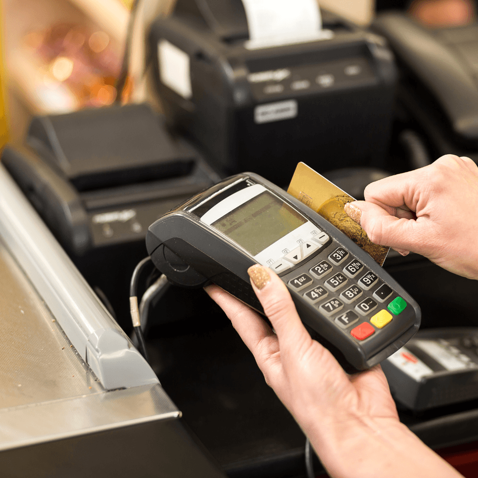 Person swiping credit card in credit card processing machine