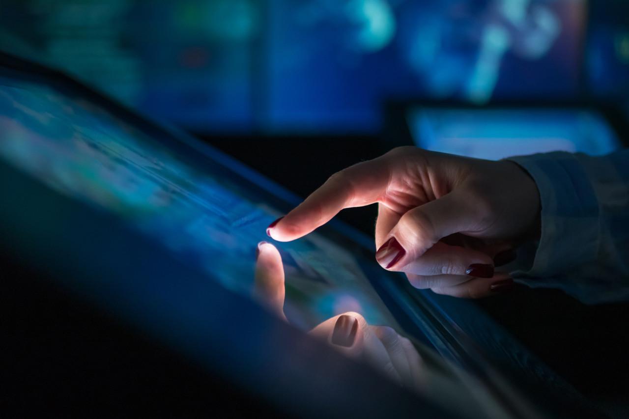 Woman touching computer screen