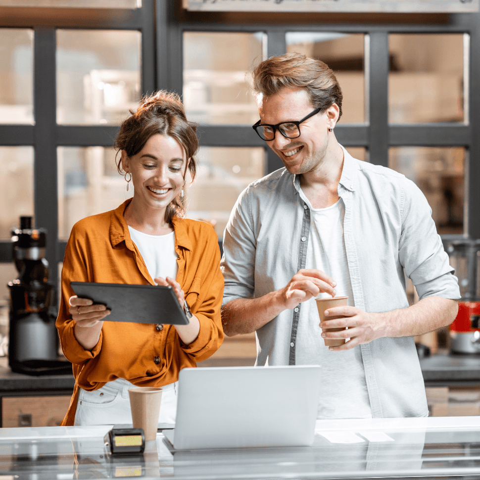 Two workers looking at a laptop